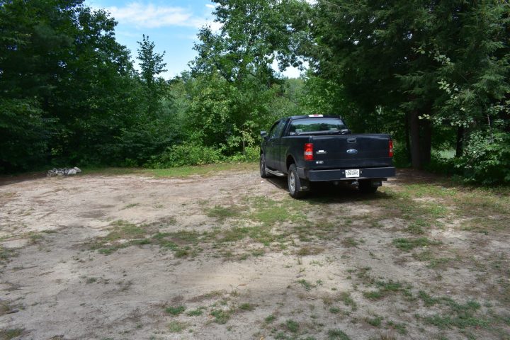 a truck driving down a dirt road
